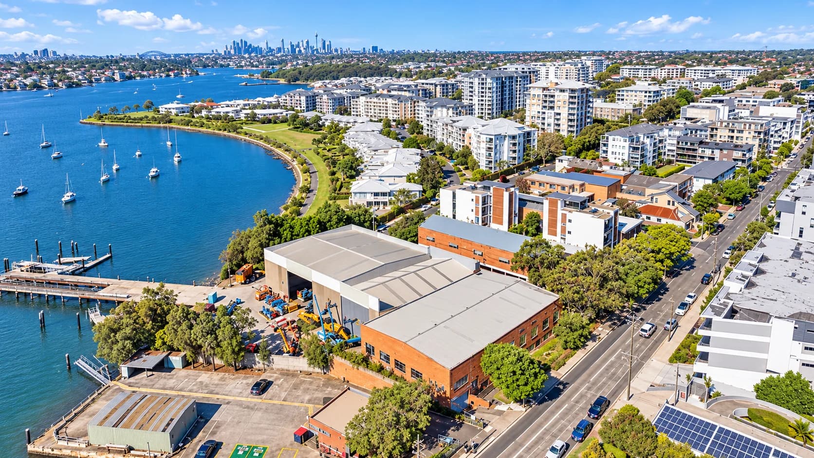 Riverfront apartment buildings beside landscaped open space