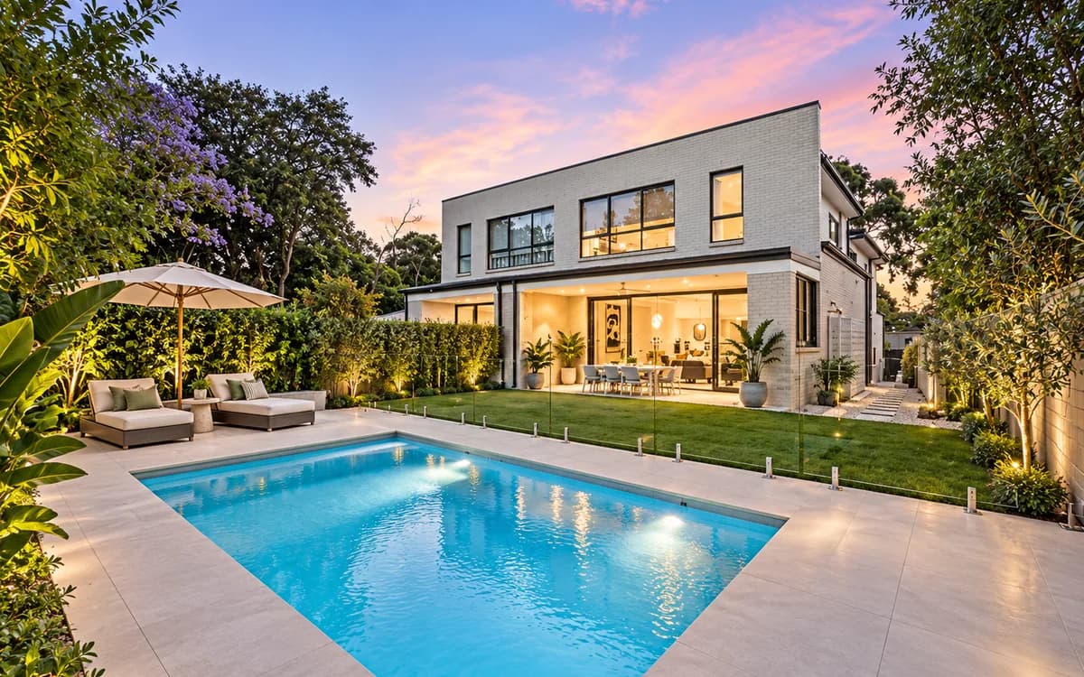 Modern house and swimming pool in Peakhurst at dusk