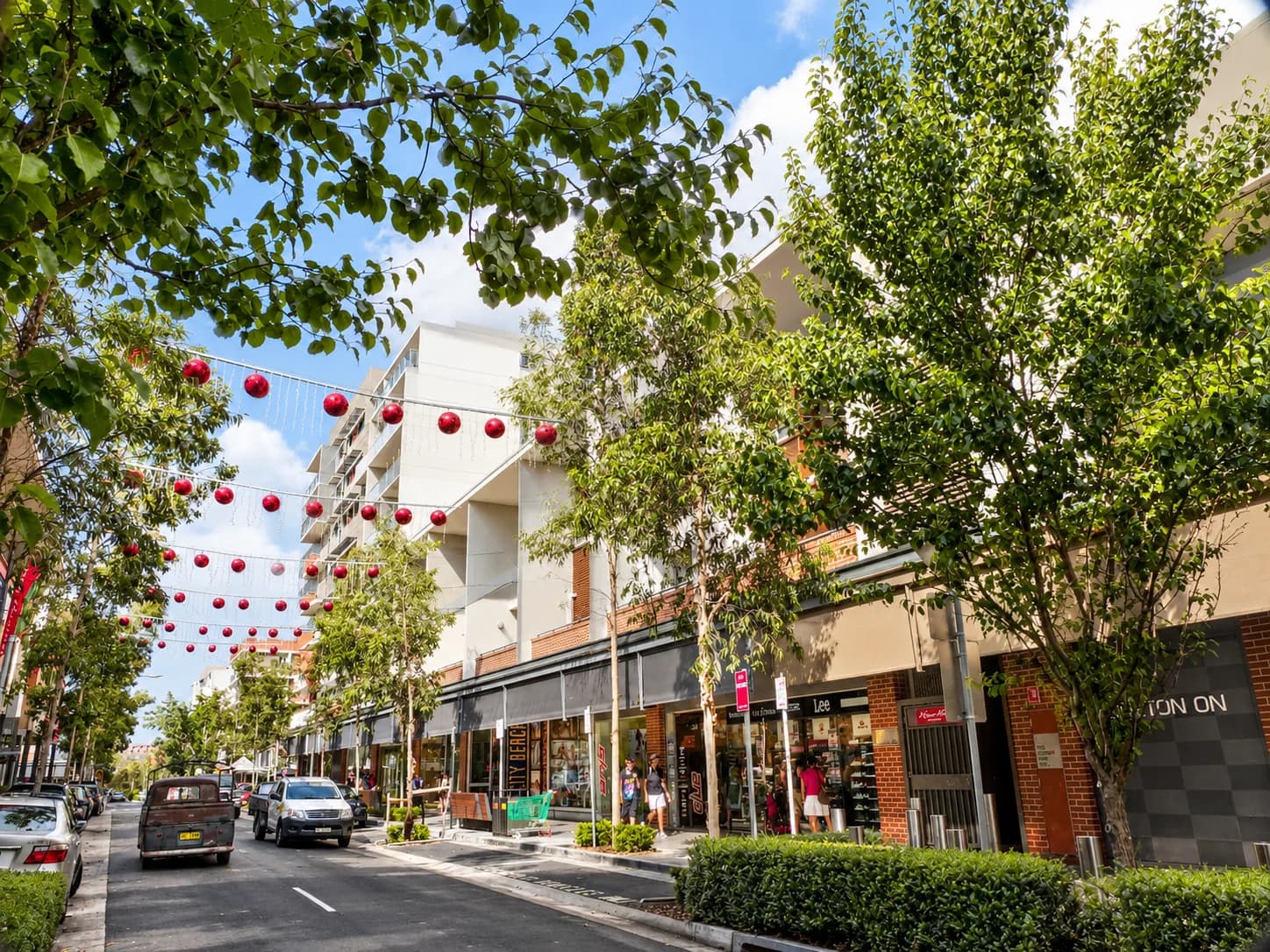 Pedestrian shopping area with cafes and trees