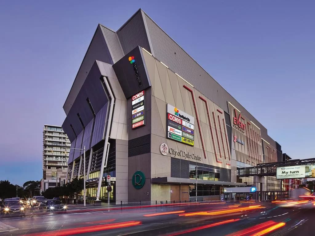 Top Ryde City shopping centre and street traffic at twilight